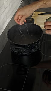A Picture of salt being added to a pot